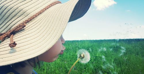 Close-up of girl blowing dandelion