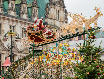 Christmas decoration against buildings in city