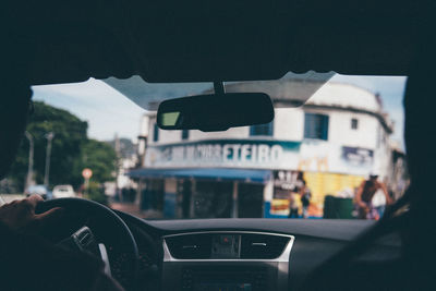 Building seen through car windshield