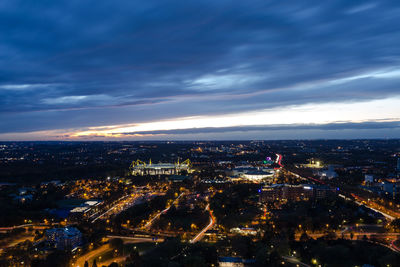 High angle view of city lit up at night