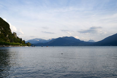 Scenic view of sea and mountains against sky