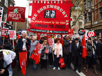 Protesters with banners on road in city