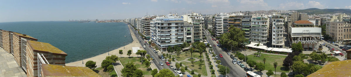 Panoramic view of buildings and sea against sky