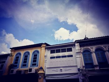 Low angle view of building against cloudy sky