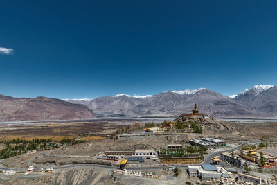 Scenic view of snowcapped mountains against clear blue sky