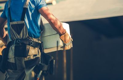 Midsection of worker working in factory