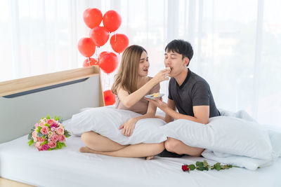 Young couple sitting on wall