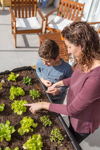 Mother and son working on a urban garden at home