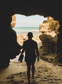 Rear view of man looking at sea shore