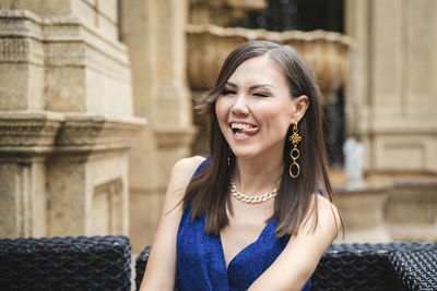 Young woman looking away while standing outdoors