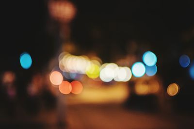 Defocused illuminated lights on street at night