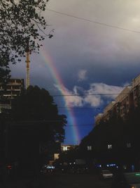 View of rainbow over city buildings