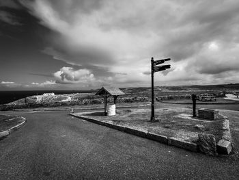Road amidst field against sky
