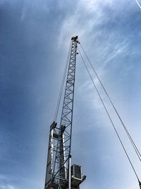 Low angle view of crane against sky