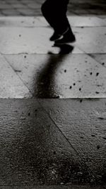 Low section of woman standing on tiled floor