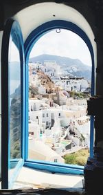 Buildings in city seen through window