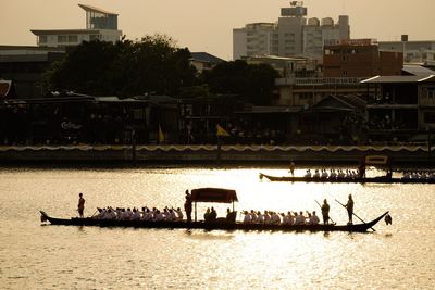 Scenic view of river by buildings against sky