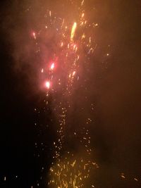 Low angle view of firework display at night