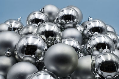 Low angle view of balloons against blue background