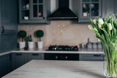 Flower vase on table at home