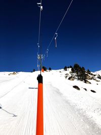 Snow covered mountain against clear blue sky