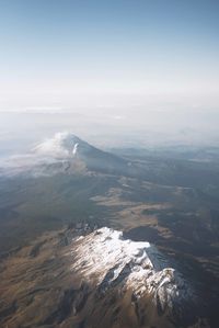 Aerial view of snowcapped mountains against sky