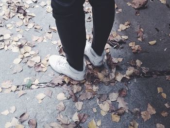 Low section of woman standing on tiled floor