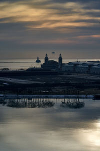 Buildings in city at sunset
