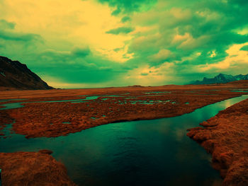 Scenic view of lake against sky during sunset