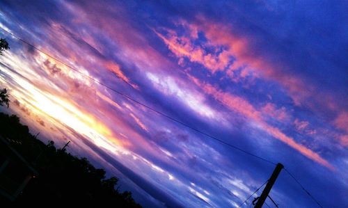 Low angle view of cloudy sky at sunset