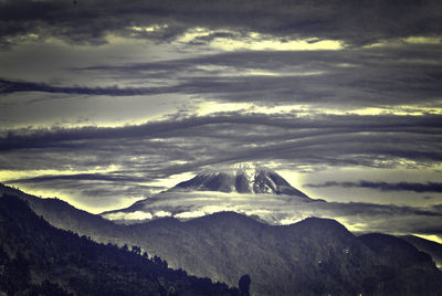 Scenic view of mountains against cloudy sky