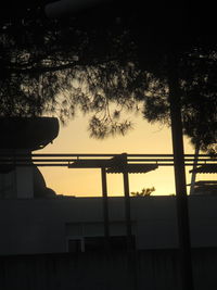 Low angle view of silhouette trees against sky