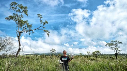 Man standing on field against sky