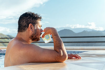 Man drinking in a pool 