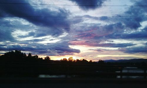 Silhouette landscape against dramatic sky