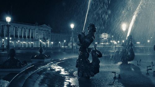 Fountain in city at night