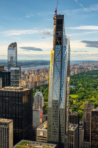 Buildings in city against cloudy sky