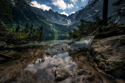 Scenic view of river flowing through mountains