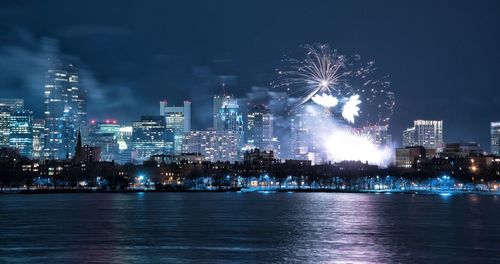 Firework display over city at night