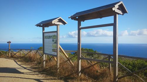 Lifeguard hut at beach against clear blue sky