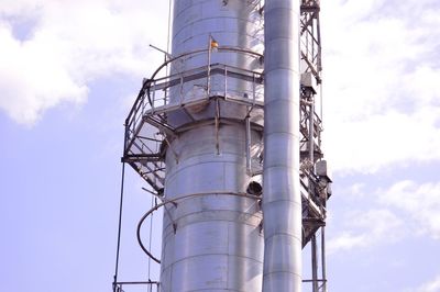 Low angle view of smoke stack against sky