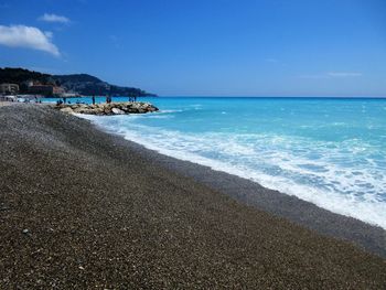 Scenic view of sea against blue sky