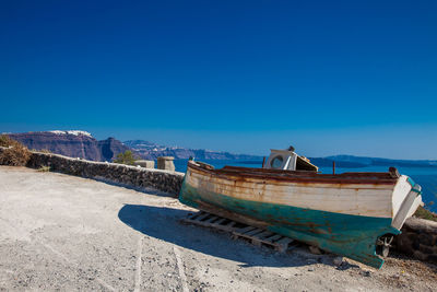 Old boat on the top of a cliff in santorini island in a beautiful early spring day