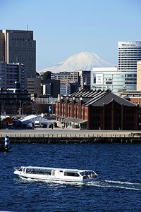 Boats in river with buildings in background