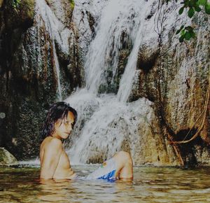 Portrait of woman in waterfall