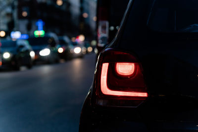 Close-up of illuminated car on road at night