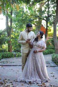 Couple standing by tree