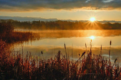 Scenic view of lake at sunset