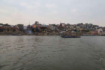 Scenic view of sea and buildings against sky