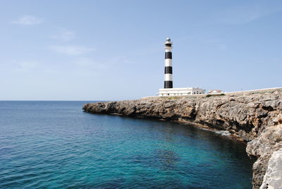 Low angle view of lighthouse at by sea at minorca